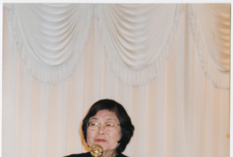 Tomoye Takahashi speaking at microphone (ddr-densho-422-576)
