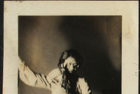 Tomoye (Nozawa) Takahashi posing with toy stuffed horse (ddr-densho-423-537)