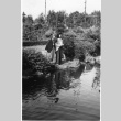 Two unidentified women in front of a pond in the Garden (ddr-densho-354-88)