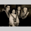 A woman and three men wearing leis (ddr-njpa-4-1684)