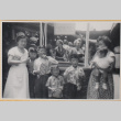 Two women and five children by wishing well (ddr-densho-522-343)