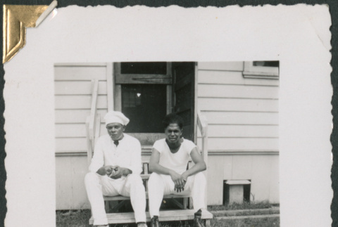 Phil Jackson and unidentified man sitting on steps (ddr-densho-434-176)