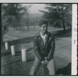 Young man sitting on bollard (ddr-densho-523-265)