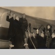 Buddhist priest and others outside an airplane (ddr-njpa-4-302)