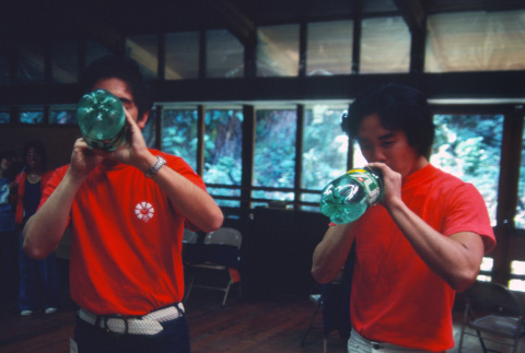 Neil Tsubota and Roger Morimoto drinking 7 Up during a camp workshop (ddr-densho-336-1300)