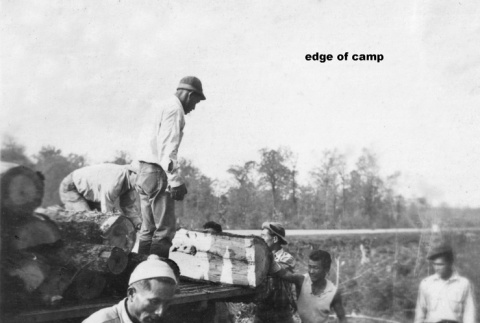 Men loading logs onto to truck (ddr-ajah-6-220)