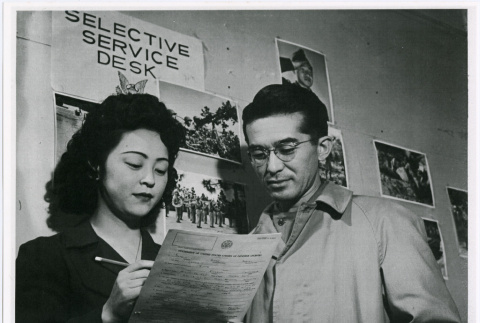 Albert Sumio Tanouye reporting to Selective Service (ddr-densho-122-763)