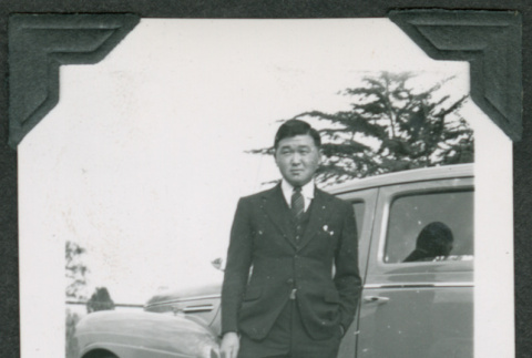 Man in a suit in front of car (ddr-densho-475-613)