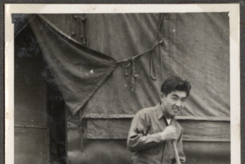 Man with broom outside tent (ddr-densho-466-95)