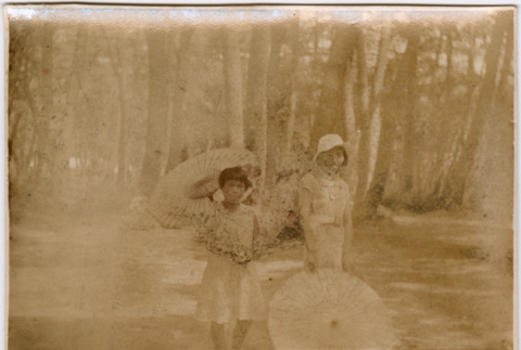 Two girls with paper parasols (ddr-densho-426-1950)