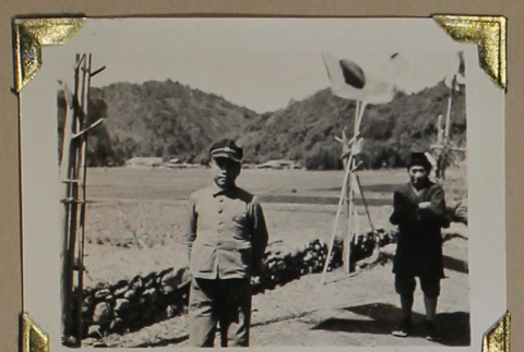 A boy and a man stand on a dirt road (ddr-densho-404-224)