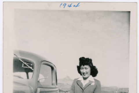 Woman poses by a car (ddr-densho-363-26)
