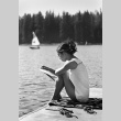 Carole Morita reading on the dock (ddr-densho-336-583)