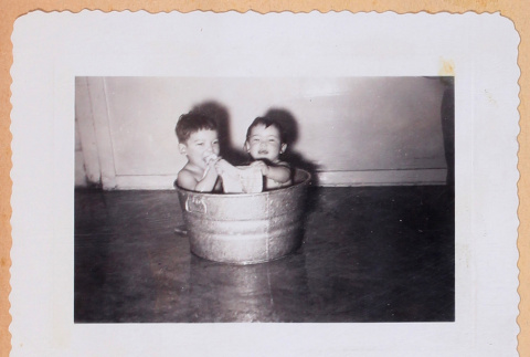 Photo of two infants in a tin basin (ddr-densho-483-487)