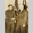 Donald D. Van Slyke shaking hands with Robert Kho-sheng Lim (ddr-njpa-1-2298)