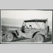 Photograph of a young boy sitting in an Army jeep in Death Valley (ddr-csujad-47-134)