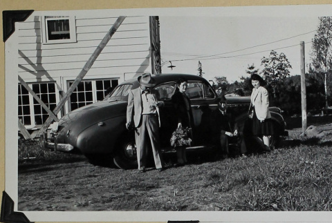 Group poses by car. (ddr-densho-359-1611)