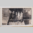 Two men and three woman on steps of wooden building (ddr-densho-464-131)