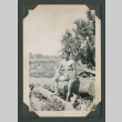 Shirtless man sitting on log (ddr-densho-471-177)