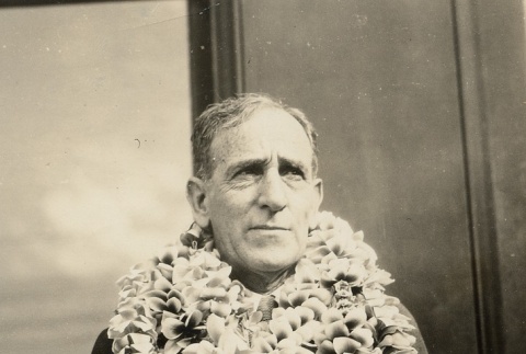 A man wearing leis (ddr-njpa-1-1954)