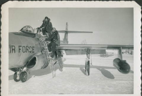 Two men getting into an Air Force plane (ddr-densho-321-318)