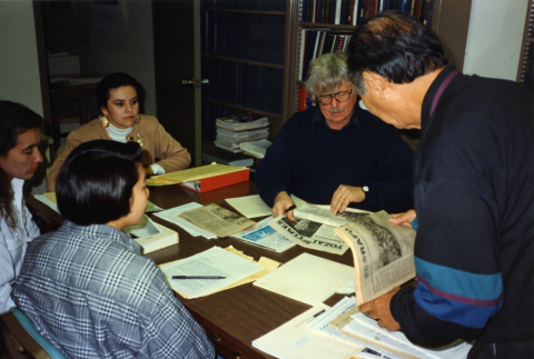 [Arthur A. Hansen, former incarceree, and students viewing Rafu Shimpo and Tozai Times newspapers] (ddr-csujad-29-310)
