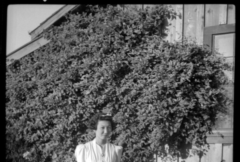 Young woman in front of ivy-covered building (ddr-densho-475-121)