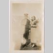 Tomoye (Nozawa) Takahashi standing with man in navel uniform (ddr-densho-426-2028)