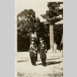 Two young boys in military dress at a shrine (ddr-njpa-8-52)