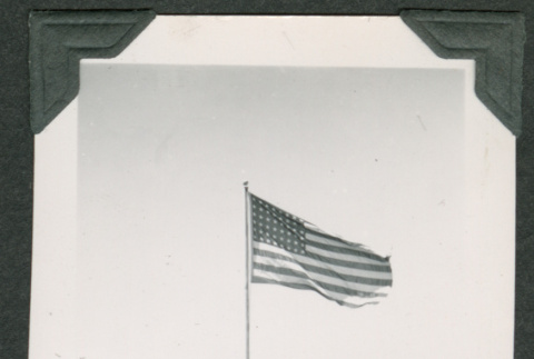 U.S. Flag with cars in background (ddr-densho-475-723)