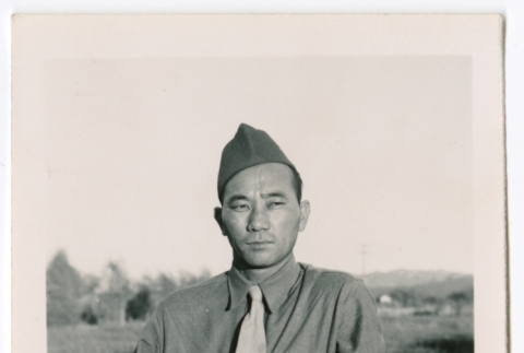 Unidentified military man standing on dirt road (ddr-densho-475-409)