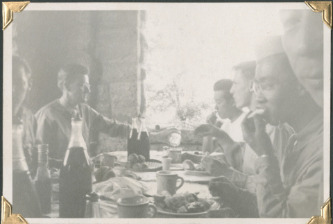 Group sitting at a table eating. (ddr-densho-434-233)