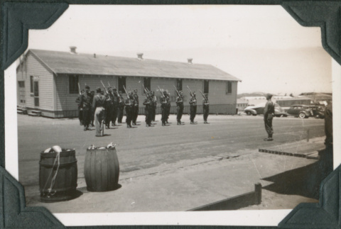 Men standing formation outside building (ddr-ajah-2-51)