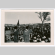 Boy scouts on stage with flag before large crowd (ddr-densho-475-383)