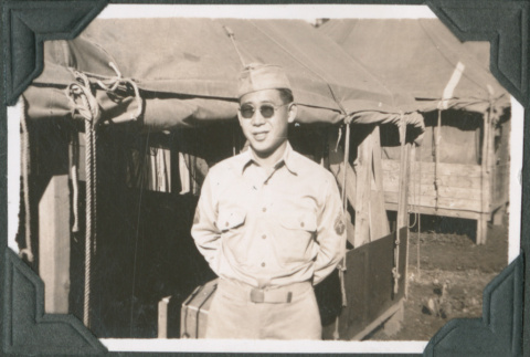 Man standing outside tent (ddr-ajah-2-587)
