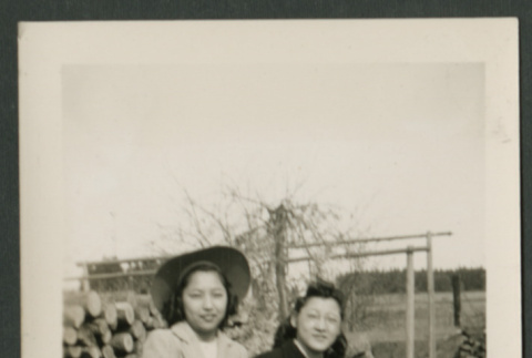 Two women pose on box (ddr-densho-359-169)