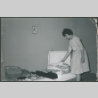 Bride packing a suitcase (ddr-densho-523-357)