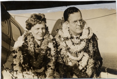Amelia Earhart and George Putnam wearing leis (ddr-njpa-1-1121)