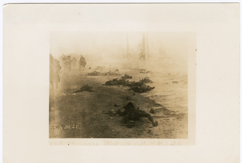Survivors walk past the burned bodies of bombing victims (ddr-densho-381-101)