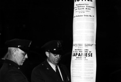 Policemen posting exclusion orders (ddr-densho-36-14)
