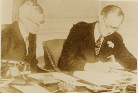 Joseph P. Kennedy and another man working at a desk (ddr-njpa-1-778)