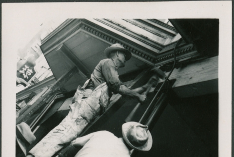 Man on ladder hammering (ddr-densho-426-2266)