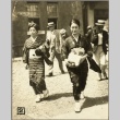 Two women walking carrying bundles of fabric (ddr-njpa-13-1358)