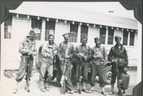 Six men with rifles standing next to car, Joe Iwataki second from  left (ddr-ajah-2-201)