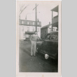Man standing next to car (ddr-densho-458-57)