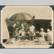 Group of children and adults at a picnic on a beach (ddr-densho-483-509)