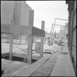 Men laying flooring on addition (ddr-densho-426-2164)