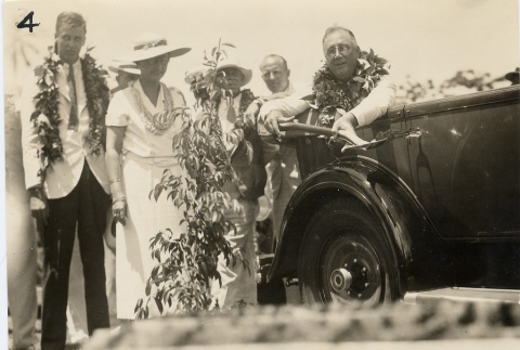 Franklin D. Roosevelt wearing leis in a car (ddr-njpa-1-1604)