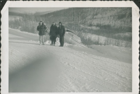 Three men standing near a car in a ditch (ddr-densho-321-333)