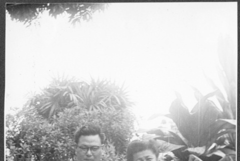 Man and woman pose in garden (ddr-densho-363-243)